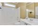 Bright bathroom featuring a white tub, shower with white tiling, and a white vanity with a sink and neutral walls at 5425 Edinbourgh Ct, Cumming, GA 30040