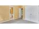 This bedroom features neutral colored walls, carpet floors, and direct access to an en-suite bathroom at 5425 Edinbourgh Ct, Cumming, GA 30040