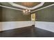 Elegant dining room with wainscoting, decorative chandelier, and hardwood floors, perfect for entertaining guests at 5425 Edinbourgh Ct, Cumming, GA 30040