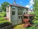 Back exterior view showcases deck, patio, and large windows at 5425 Edinbourgh Ct, Cumming, GA 30040
