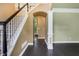 Inviting foyer with hardwood floors, a staircase with carpet, and an arched entrance leading to other rooms at 5425 Edinbourgh Ct, Cumming, GA 30040