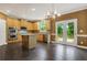 Bright kitchen includes stainless appliances, island, and French doors to the patio with a wooded view at 5425 Edinbourgh Ct, Cumming, GA 30040