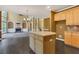 Kitchen island and views to the living room featuring tall ceilings and fireplace with built-ins at 5425 Edinbourgh Ct, Cumming, GA 30040