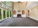 Bright living room features a fireplace, built-in shelves and large windows overlooking the wooded yard at 5425 Edinbourgh Ct, Cumming, GA 30040