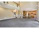 Spacious living room showing kitchen and stair access with tall ceilings and lots of natural light at 5425 Edinbourgh Ct, Cumming, GA 30040