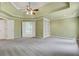 This large main bedroom offers tray ceilings, a ceiling fan, an en-suite bathroom, and built-in shelving at 5425 Edinbourgh Ct, Cumming, GA 30040