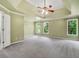 This spacious main bedroom features a tray ceiling, neutral-colored walls, and large windows for natural light at 5425 Edinbourgh Ct, Cumming, GA 30040