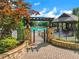 Gated entrance to the community pool area featuring a pergola and shaded seating at 5425 Edinbourgh Ct, Cumming, GA 30040