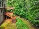 Multi-level wooden deck and landscaped backyard perfect for outdoor living at 5425 Edinbourgh Ct, Cumming, GA 30040