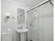 Bathroom featuring a glass-door shower, a sink with a pedestal and a clean modern toilet at 215 Piedmont Ne Ave # 2109, Atlanta, GA 30308