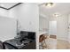 A compact kitchen featuring a black electric range and a view into the adjacent breakfast bar at 215 Piedmont Ne Ave # 2109, Atlanta, GA 30308