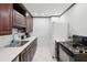 Classic kitchen featuring dark cabinetry, stainless steel appliances, and white tile flooring at 215 Piedmont Ne Ave # 2109, Atlanta, GA 30308