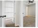 Bright bedroom with neutral carpet, ceiling fan and opened closet and storage spaces at 3505 Miller St # D, Lithia Springs, GA 30122