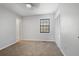 Carpeted bedroom showcasing large window, closet spaces and adjacent doorways at 3505 Miller St # D, Lithia Springs, GA 30122