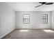 Empty bedroom featuring neutral carpet, black frame windows and ceiling fan at 3505 Miller St # D, Lithia Springs, GA 30122