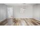 An open dining room with hardwood floors, neutral paint, and modern lighting at 3505 Miller St # D, Lithia Springs, GA 30122