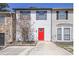 Charming townhome featuring a vibrant red front door and mature landscaping at 3505 Miller St # D, Lithia Springs, GA 30122