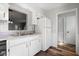 Classic white kitchen with white cabinets, countertops, and stainless steel double bowl sink at 3505 Miller St # D, Lithia Springs, GA 30122