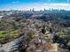 Expansive aerial view of the city skyline over a neighborhood of trees and homes with visible parking at 578 Cedar Avenue, Atlanta, GA 30318