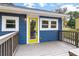 Charming outdoor porch with blue siding and a vibrant yellow door at 578 Cedar Avenue, Atlanta, GA 30318
