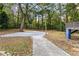 Spacious backyard with mature trees, a patio area, and lush green surroundings at 578 Cedar Avenue, Atlanta, GA 30318