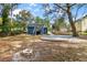 Spacious backyard featuring a fire pit, a patio space, and lush trees at 578 Cedar Avenue, Atlanta, GA 30318