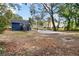 Large backyard featuring a fire pit and gravel patio, surrounded by mature trees at 578 Cedar Avenue, Atlanta, GA 30318