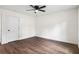 Bright, empty bedroom boasts dark vinyl floors, white walls, and a modern ceiling fan at 578 Cedar Avenue, Atlanta, GA 30318