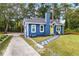 Charming blue home with a yellow door, stone walkway, and lush green lawn at 578 Cedar Avenue, Atlanta, GA 30318