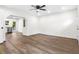 Bright living room with hardwood floors and a modern ceiling fan, leading to an open-concept kitchen at 578 Cedar Avenue, Atlanta, GA 30318