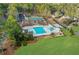 Aerial view of community pool and recreation area, with pools, tennis courts, and playground at 1112 Kensington Ct, Johns Creek, GA 30022