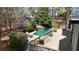 Lush backyard with private pool, waterfall feature, and wooden deck at 1112 Kensington Ct, Johns Creek, GA 30022