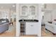 Convenient bar area featuring granite countertops, a sink, a wine cooler, and display cabinets at 1112 Kensington Ct, Johns Creek, GA 30022