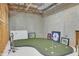 Unique basement featuring a putting green and baseball memorabilia at 1112 Kensington Ct, Johns Creek, GA 30022