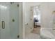 Bright bathroom features a tiled shower and a view into an adjacent bedroom at 1112 Kensington Ct, Johns Creek, GA 30022
