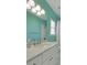 Bright bathroom featuring a white vanity with a quartz countertop and mint walls at 1112 Kensington Ct, Johns Creek, GA 30022