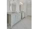 Bathroom featuring double vanities, modern fixtures, and marble tile floor at 1112 Kensington Ct, Johns Creek, GA 30022