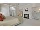 Bright bedroom with a fireplace, a vaulted ceiling, and access to a balcony at 1112 Kensington Ct, Johns Creek, GA 30022