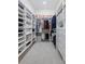 Well-organized walk-in closet with built-in shelves and drawers at 1112 Kensington Ct, Johns Creek, GA 30022