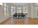Bright dining room with large windows, wood floors, and a stylish chandelier at 1112 Kensington Ct, Johns Creek, GA 30022