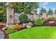 Stone and brick community entrance featuring lush landscaping and mature trees at 1112 Kensington Ct, Johns Creek, GA 30022