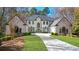 Elegant two-story home with well-manicured lawn and circular driveway at 1112 Kensington Ct, Johns Creek, GA 30022