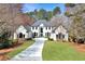 Stately two-story home with a well-manicured lawn and a long, paved driveway at 1112 Kensington Ct, Johns Creek, GA 30022