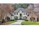 Stately two-story home featuring a manicured lawn and a circular driveway at 1112 Kensington Ct, Johns Creek, GA 30022