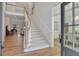Grand foyer with staircase, hardwood floors, and view into the study at 1112 Kensington Ct, Johns Creek, GA 30022
