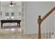 Inviting game room with a pool table, built-in shelving, and natural light at 1112 Kensington Ct, Johns Creek, GA 30022