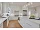 Beautiful white kitchen with large island, stainless steel appliances and hardwood floors at 1112 Kensington Ct, Johns Creek, GA 30022