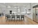 Bright kitchen features white cabinetry, a large island with seating, and stainless steel appliances at 1112 Kensington Ct, Johns Creek, GA 30022