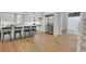 Open kitchen design with hardwood flooring, white cabinets and stainless steel appliances at 1112 Kensington Ct, Johns Creek, GA 30022