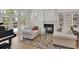 Comfortable living room with a fireplace, piano, and view of the outside through large glass doors at 1112 Kensington Ct, Johns Creek, GA 30022